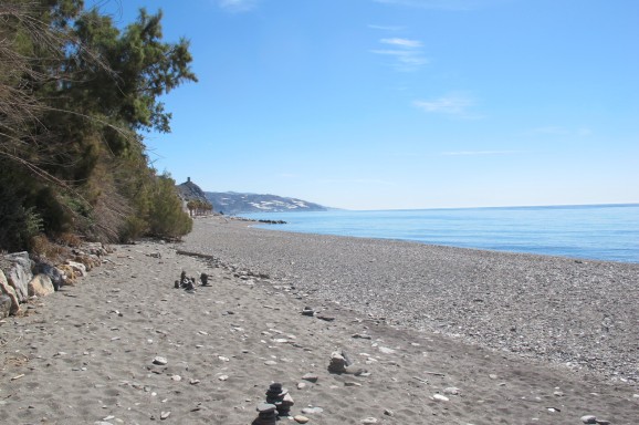 Beach at Castillo de Baños - grey sand but spotlessly clean. Beach at Castillo de Baños - grey sand but spotlessly clean.