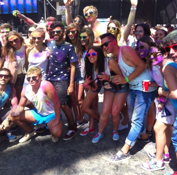 In bright sunshine, festival goers show off their colourful garb.