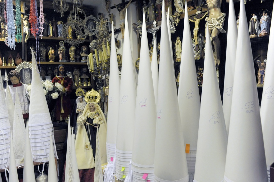 Cone-shaped inner moulds for the tall, pointed headwear of the Nazarenos are stacked in corners, their sizes and heights marked in pencil and tagged with handwritten Post-its—a system charming in its simplicity. Michelle Chaplow