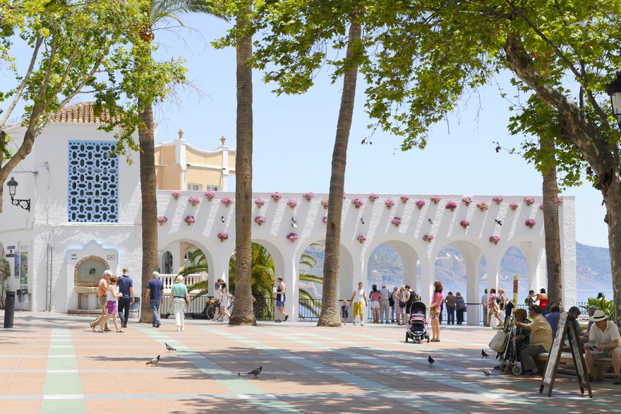 Arches bathed in sunlight, flower pots in bloom — Nerja’s Balcón de Europa © Michelle Chaplow