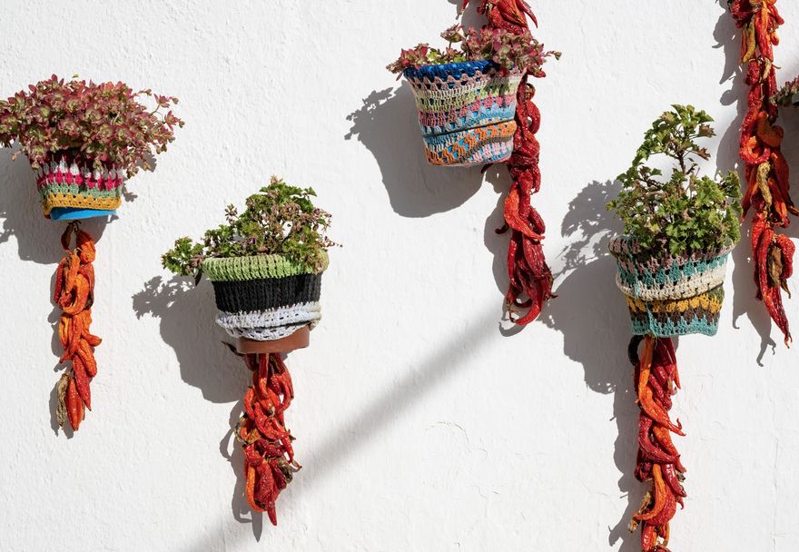 Trevélez, Andalucía—plant pots wrapped in colorful knitted covers bask in the sun, while peppers and chilies hang to dry in the warm mountain air © Michelle Chaplow
