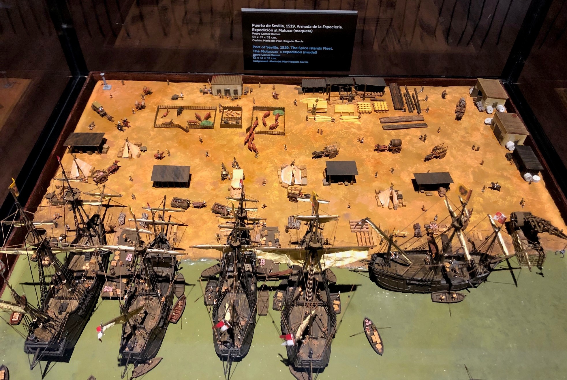 Scale model of the Nao Victoria, and of the full fleet moored at Seville's port 