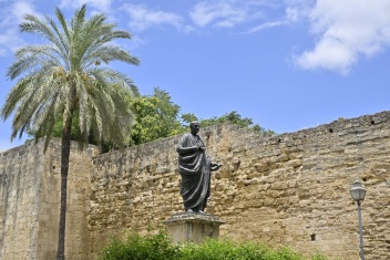 Statue of the Roman philosopher Seneca near Puerta de Almodóvar and the ancient city walls of Córdoba, Spain — a tribute to one of the city’s most renowned historical figures. © Michelle Chaplow