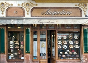 Marble and carved wood frame the historic facade of Maquedano Hat Shop in Seville © Fiona Flores 