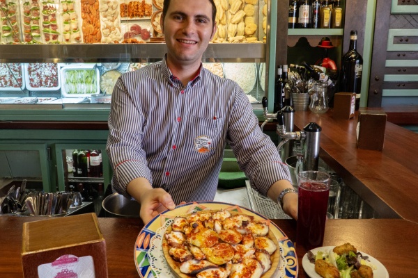 Service with a smile at a Seville tapas bar. © Michelle Chaplow