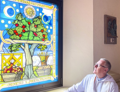 Reverend Dr. Tony Carroll contemplating the stained glass window of Sotogrande parish church © Michelle Chaplow