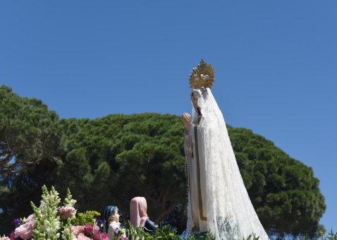 The procession winds its way through the scenic paths lined with umbrella pine trees,