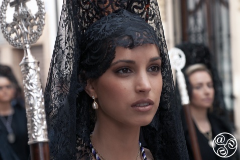 Manola - Lady wearing a black mantilla (long lace veil), black dress and crucifix necklace, black gloves and shoes, and carrying a rosary Manola - Lady wearing a black mantilla (long lace veil), black dress and crucifix necklace, black gloves and shoes, and carrying a rosary © Michelle Chaplow