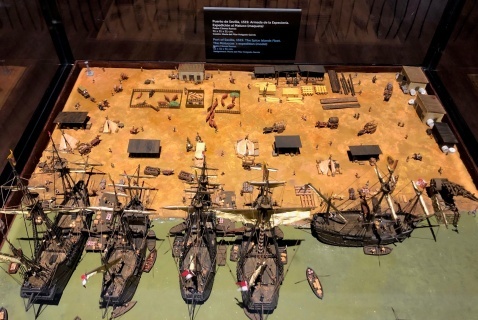 Scale model of the Nao Victoria, and of the full fleet moored at Seville's port 